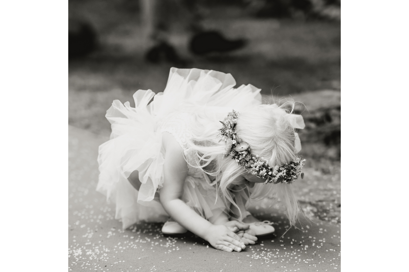 A girl picking up rice from the ground