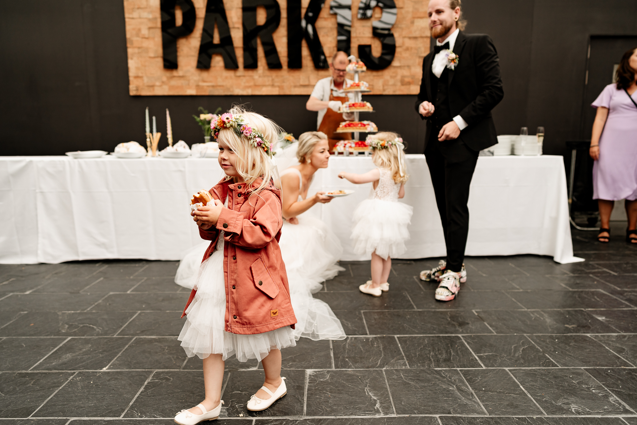 A girl with a burger at a wedding reception