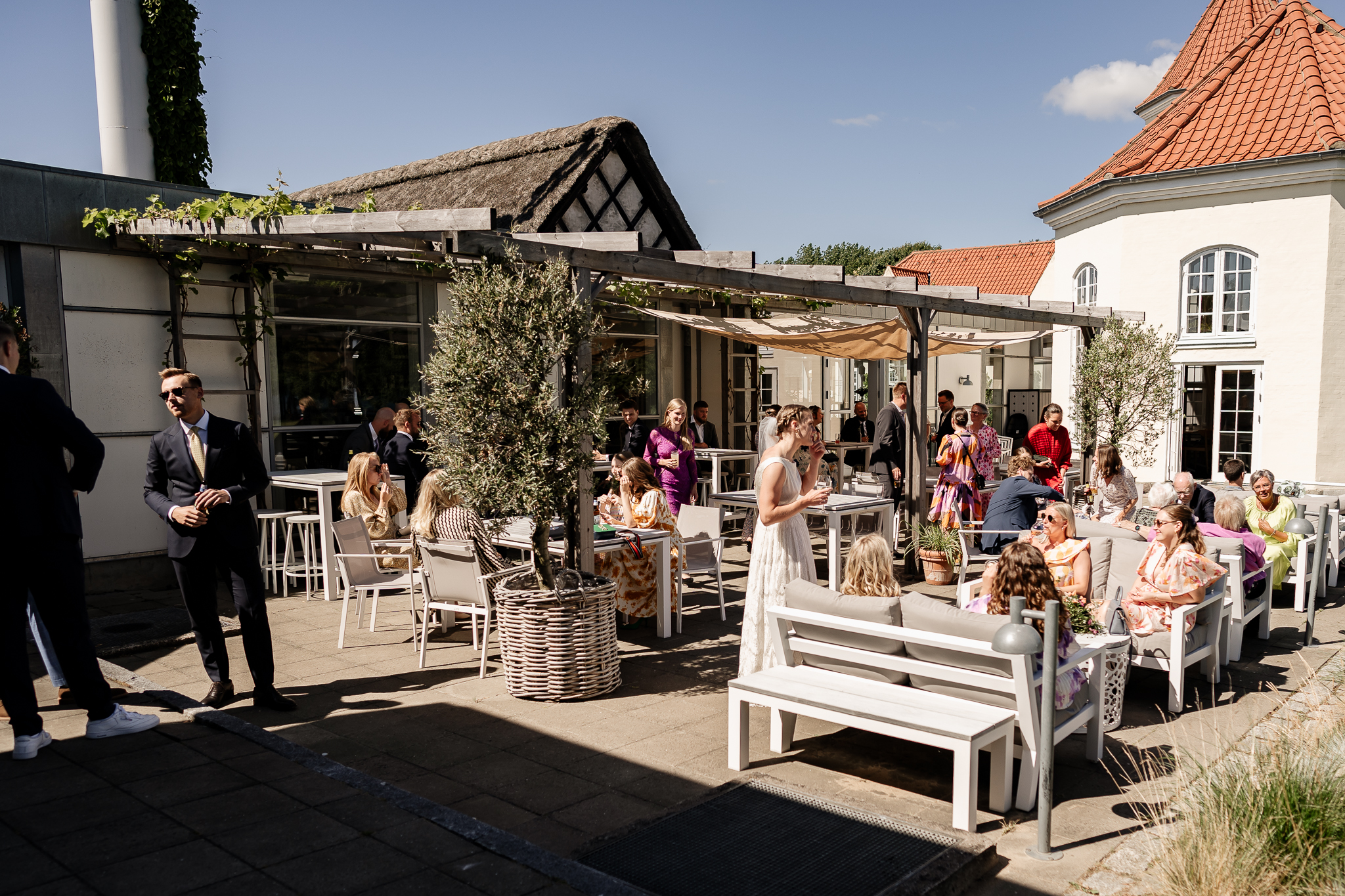 A lot of people gathered outside for a wedding reception