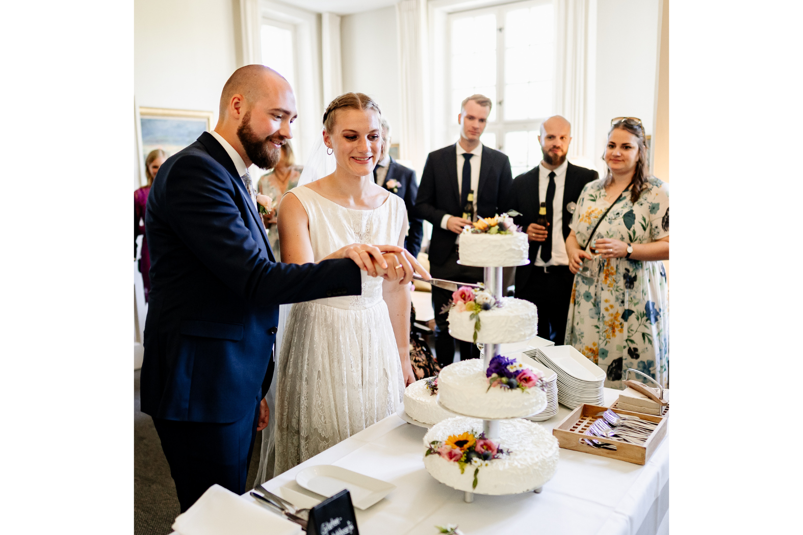 A bride and a groom cutting the wedding cake