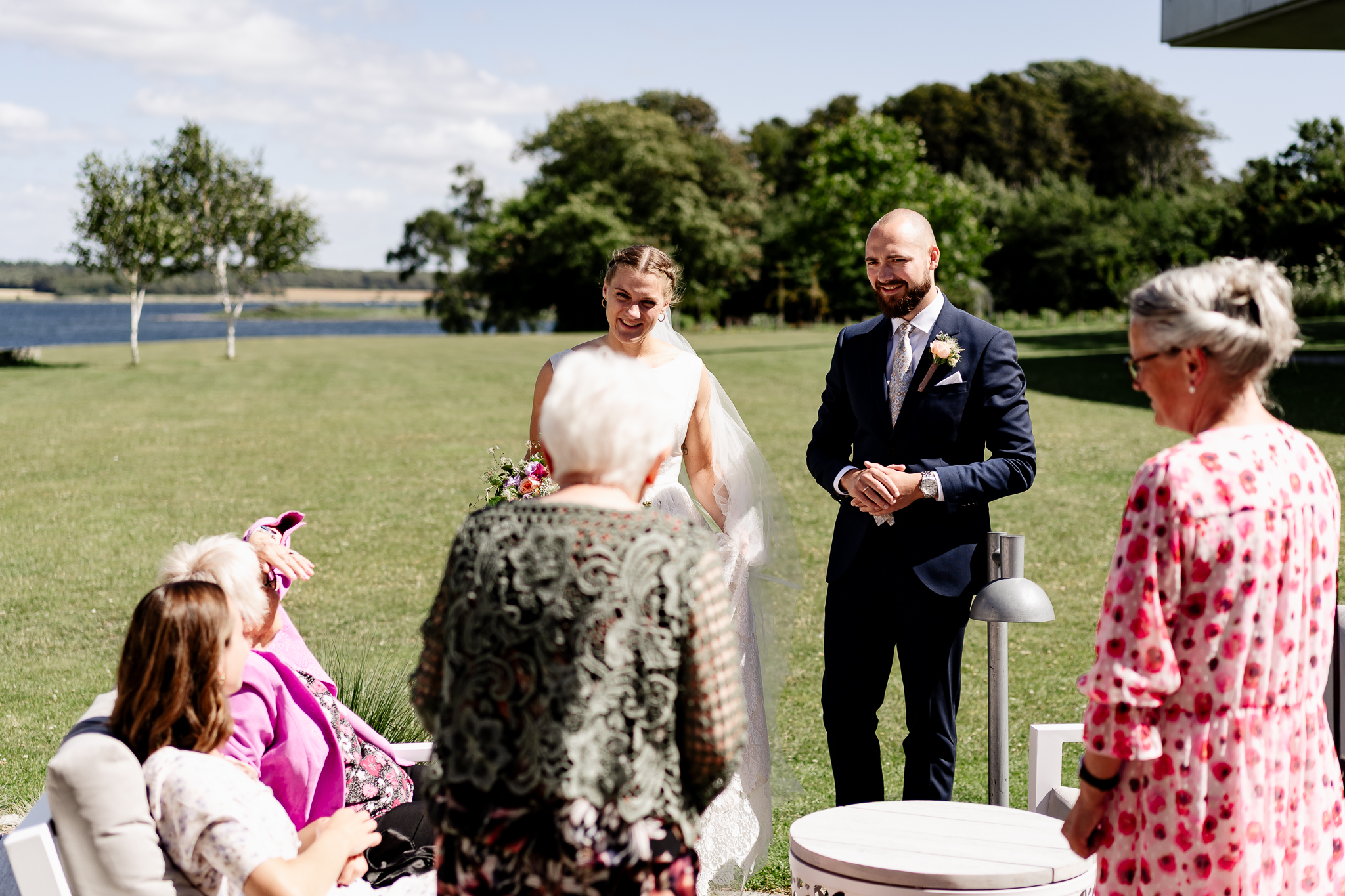 A bride and a groom talking to their guests