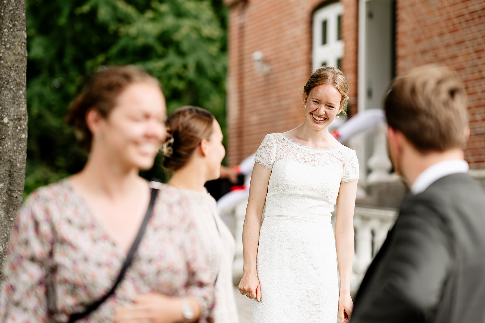 A bride smiling for some of the guests