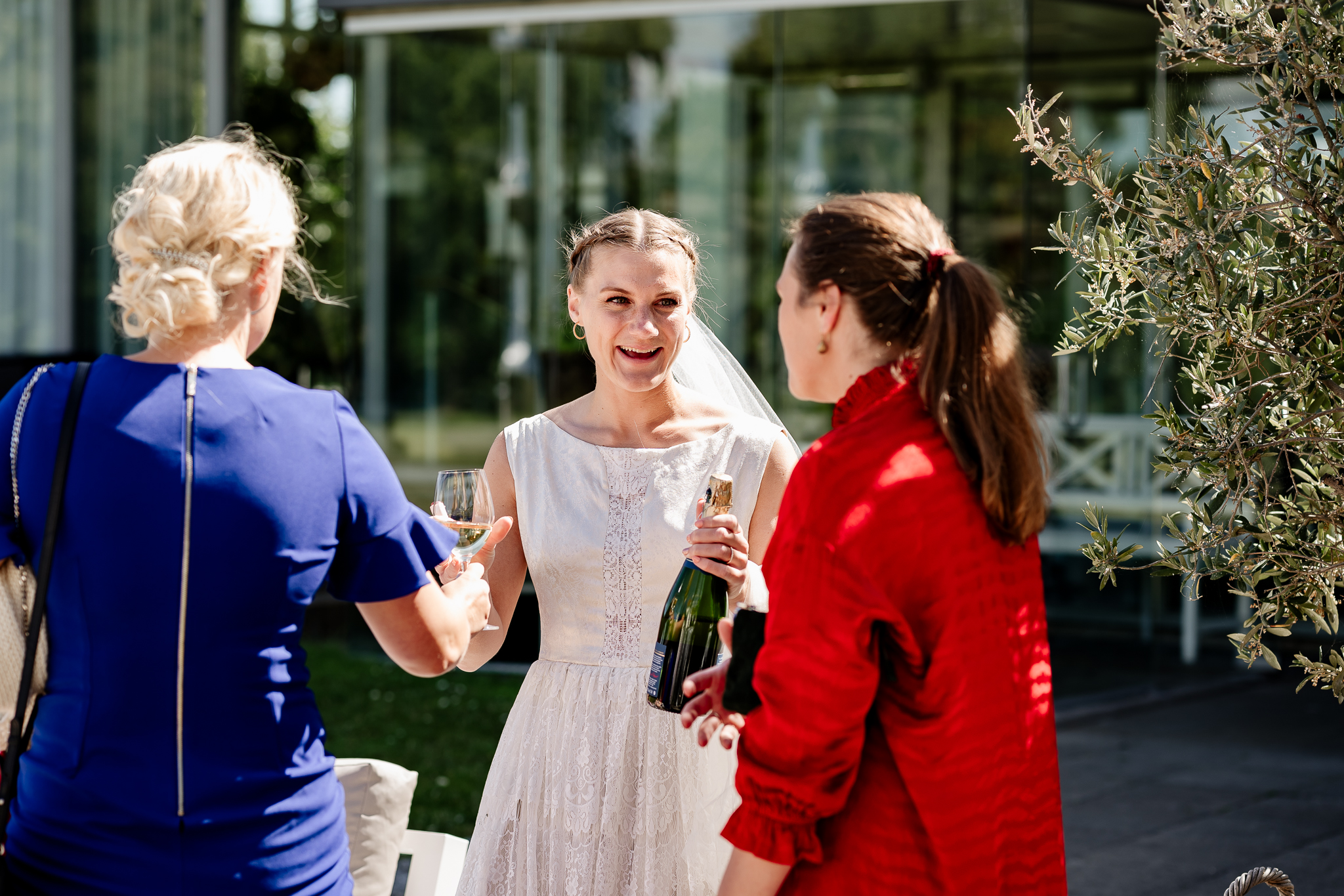 A bride smiling at some of the guests