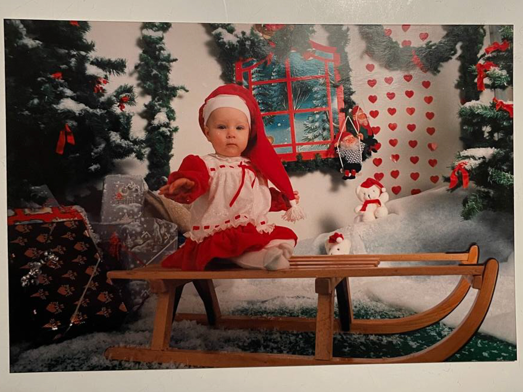 A little girl sitting on a sledge